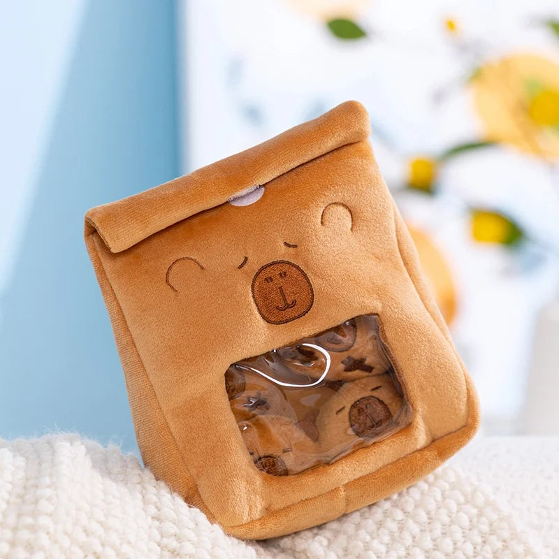 Brown capybara-shaped box with a clear window on a white surface with a blurred background
