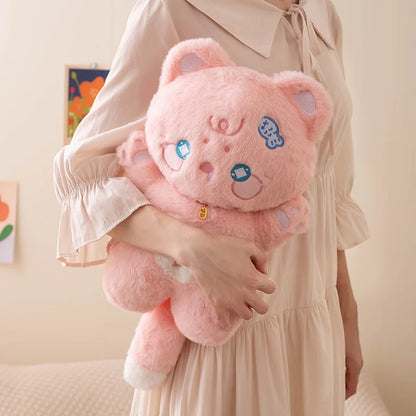 Person holding a pink plush toy with cartoon cat face design against a neutral background