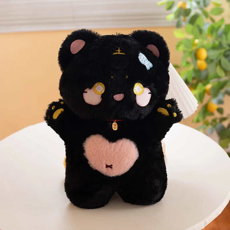 Black cat plush toy with a heart on a white surface