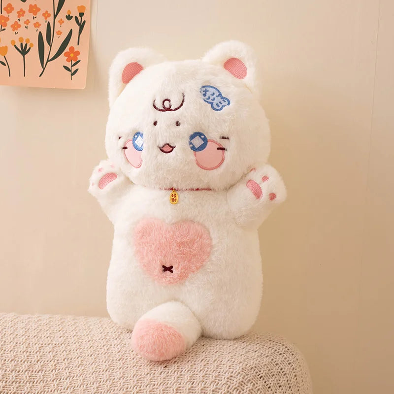 Cute cat plush toy with a heart on a beige surface