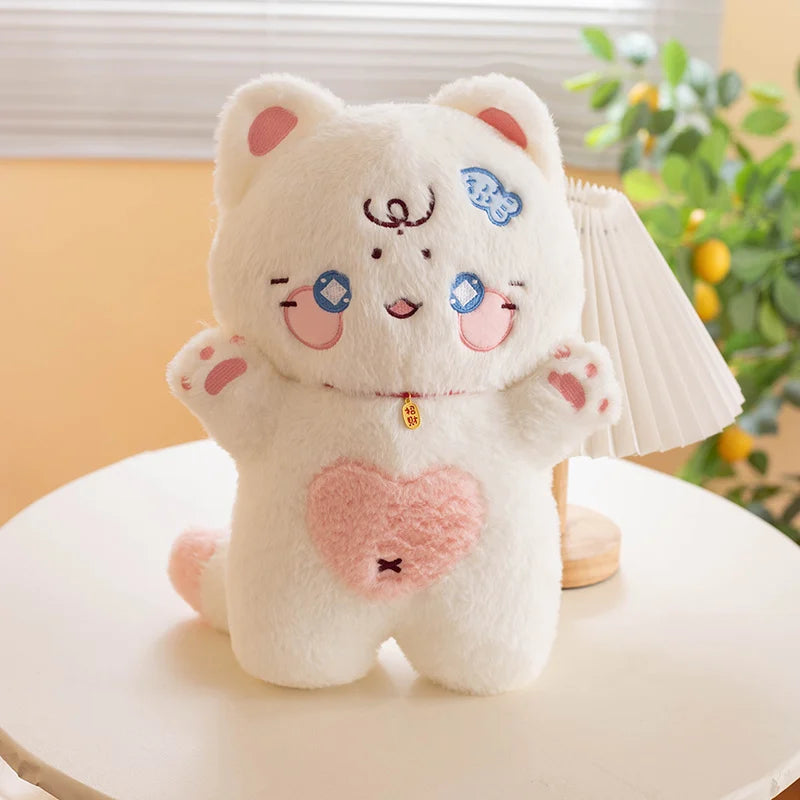 Cute white cat plush toy with a heart design on a white surface