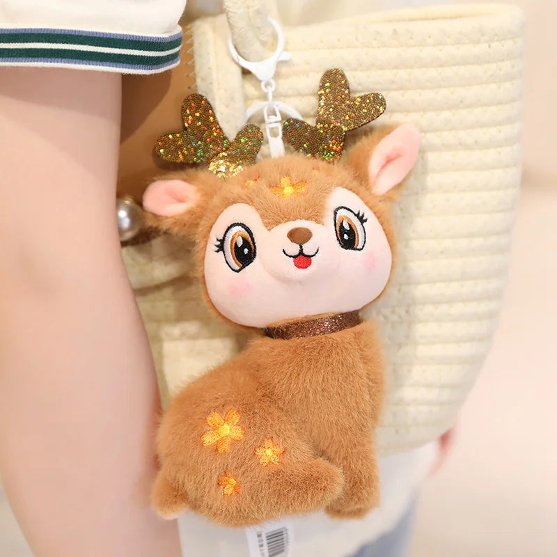 Plush deer toy with glittery antlers held by a person
