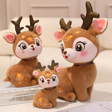 Three plush deer toys with glowing eyes on a white surface.