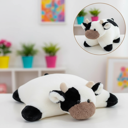 Plush cow toy on a white surface with a colorful background