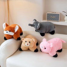 Four plush toys (fox, elephant, bear, pig) on a white couch with a small amplifier in the background.