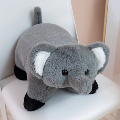 Gray plush elephant toy on a white surface