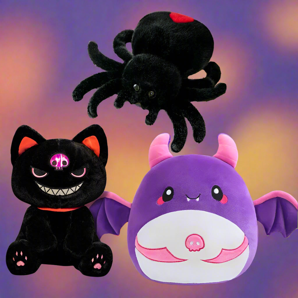 Three Halloween plush toys: a black spider, a black cat, and a purple bat with pink accents on a white background.