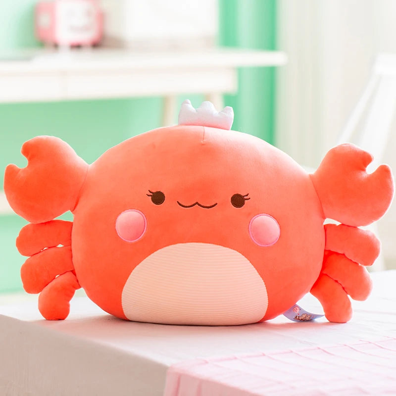 Plush crab toy on a light surface with a blurred background