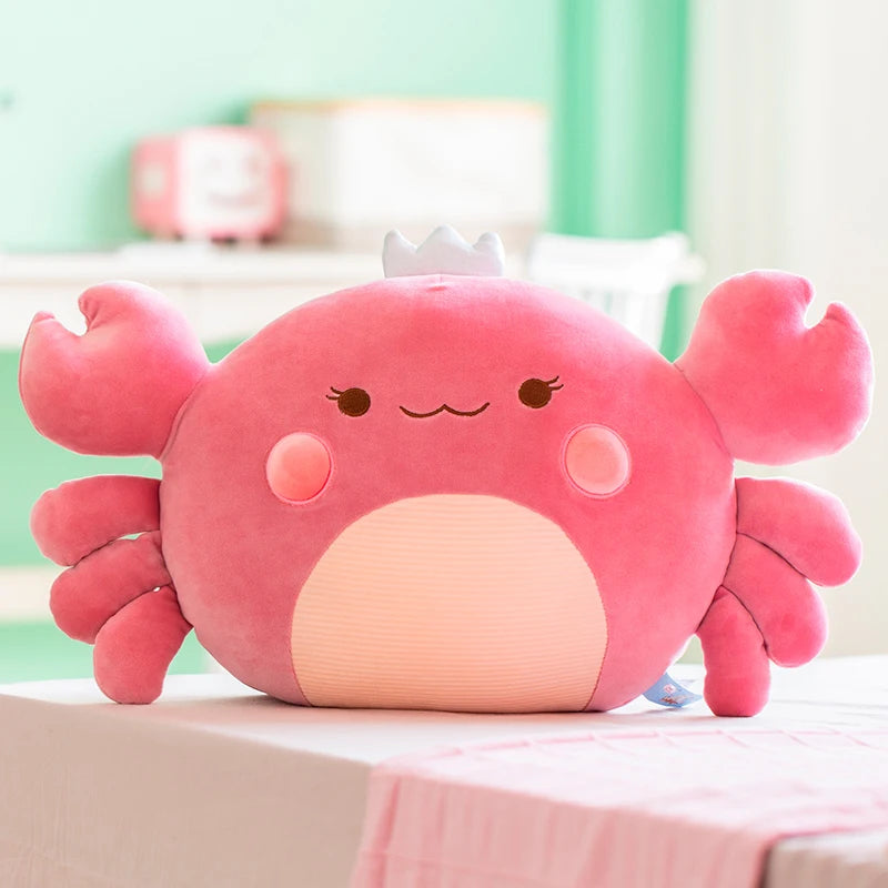 Purple crab-shaped plush toy on a light surface with a blurred background