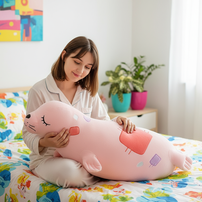 Woman holding a large pink seal plush toy in a bright room with colorful bedding and plants.