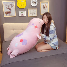 Woman holding a large Kawaii Sea Lion Plushie in a bedroom setting