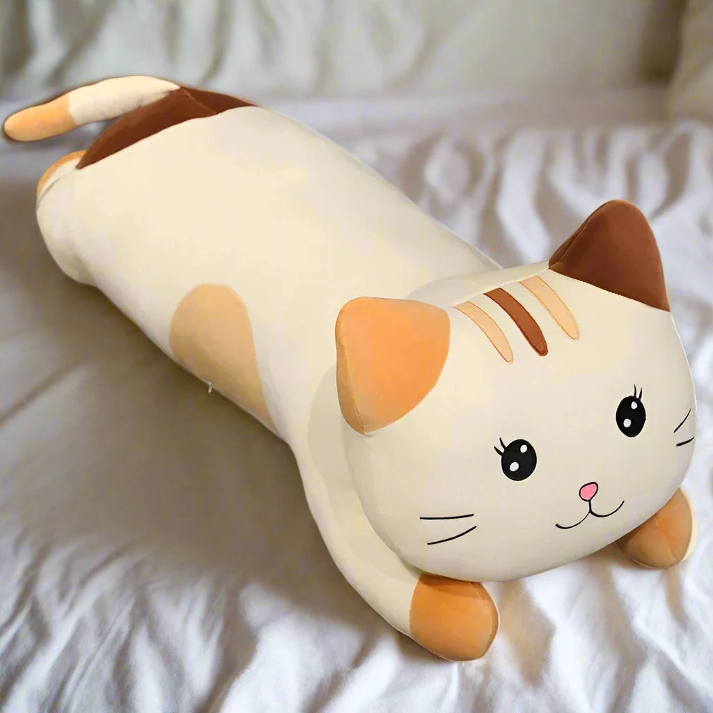 Cat-shaped plush pillow on a textured surface