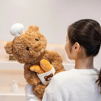 Girl Holding Brown Bear Plushie Wearing Bakers Hat Holding Bread