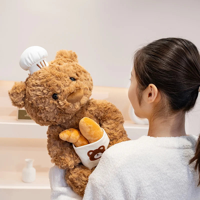 Girl Holding Brown Bear Plushie Wearing Bakers Hat Holding Bread