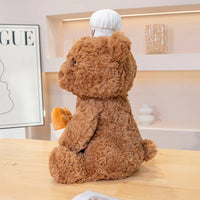 Brown Bear Plushie Wearing Bakers Hat Holding Bread Side View