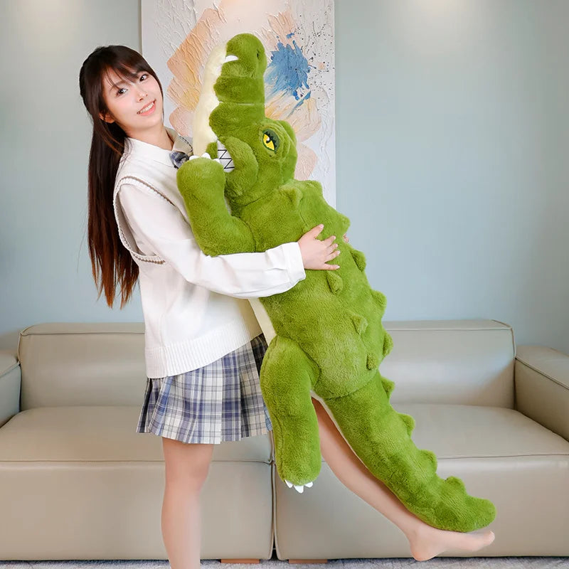 Person holding a large green crocodile plush toy in a living room setting