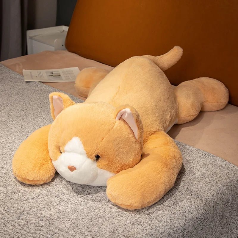 Plush cat toy on a bed with a neutral background