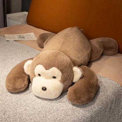 Brown monkey plush toy lying on a bed