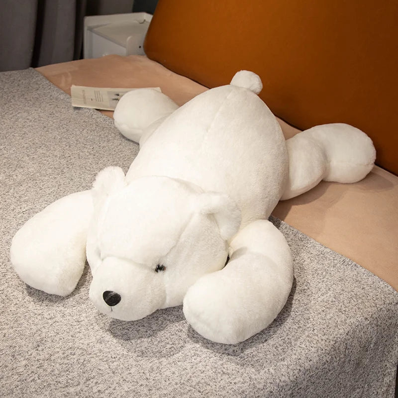 White teddy bear lying on a textured surface with a blurred background