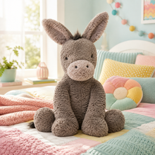 A plush donkey stuffed animal sits centered on a pastel quilted bed in a bright, soft bedroom. The donkey is taupe-gray with a cream snout and small black eyes.