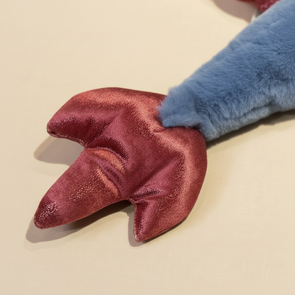 Red glittery plush dragons tail on a beige background