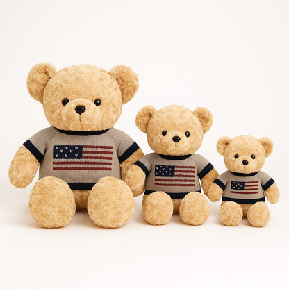Three teddy bears wearing American flag sweaters on a white background