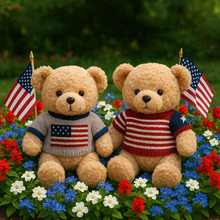 Two teddy bears wearing American flag sweaters sitting among flowers with American flags in the background.