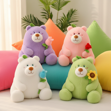 Four colorful teddy bears with flower accessories on a soft surface.
