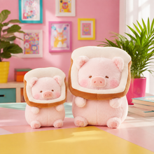 Two plush pig toys styled like wearing toast hats, one small and one large, sitting on a colorful pastel surface with a pink framed wall background and potted plants.