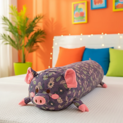 Floral-patterned pig-shaped body pillow on a bed with colorful pillows and an orange wall in the background.