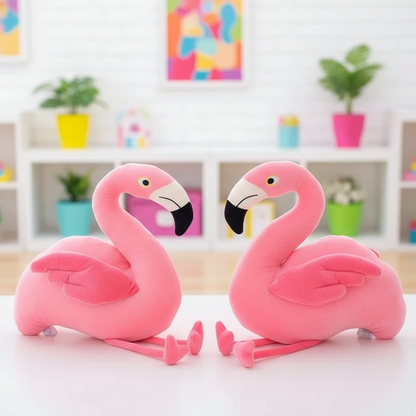 Two pink flamingo plush toys on a white surface with a colorful background.