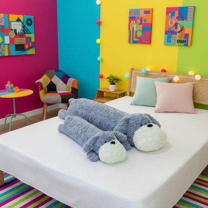 Blue dog plushie body pillow laying on a bed in a vibrant bedroom setting
