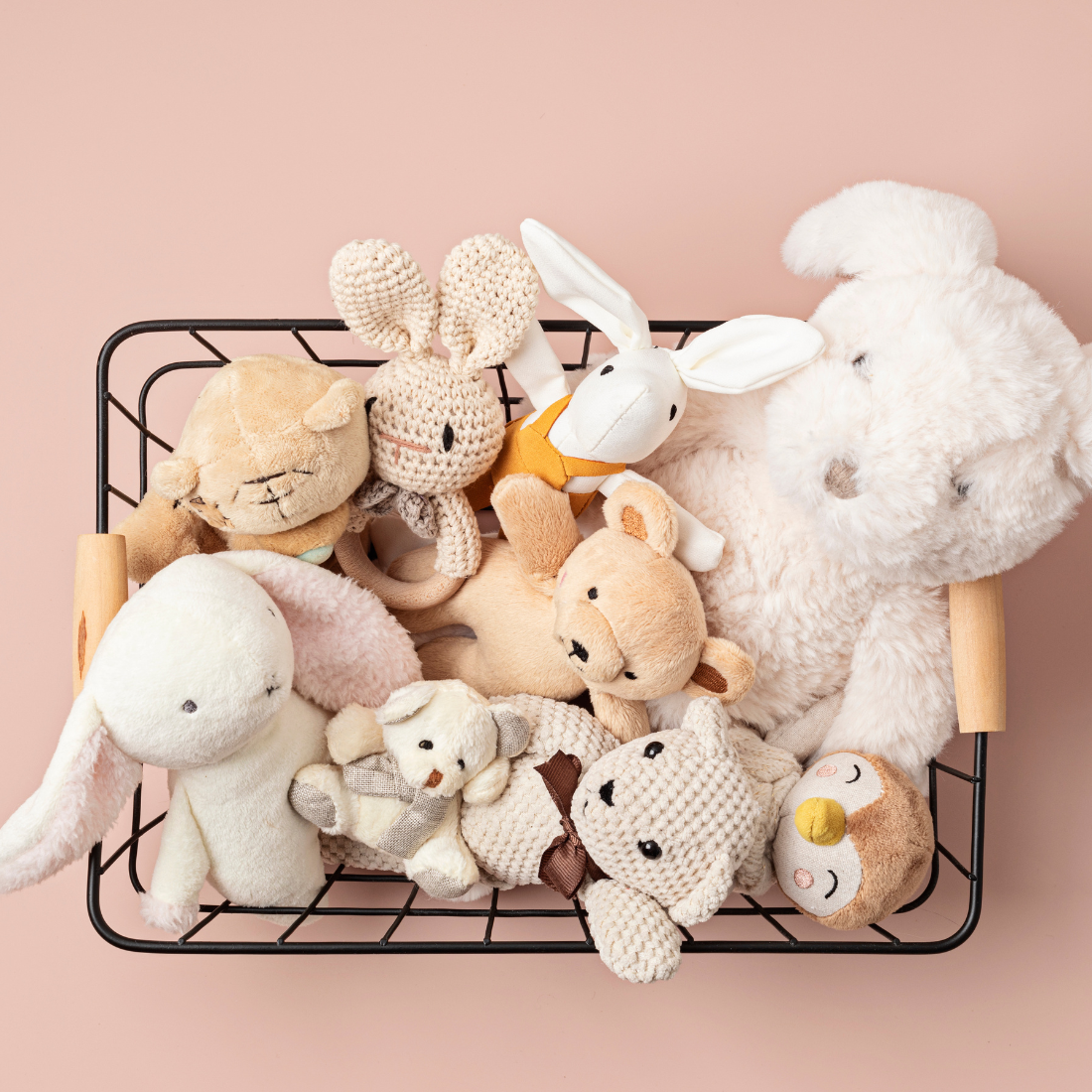 A wire basket full of various animal plush toys