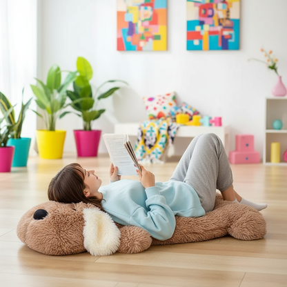 Person lying on a large plush dog pillow reading a book in a colorful living room.