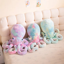 Pastel-colored octopus plush toys on a beige sofa