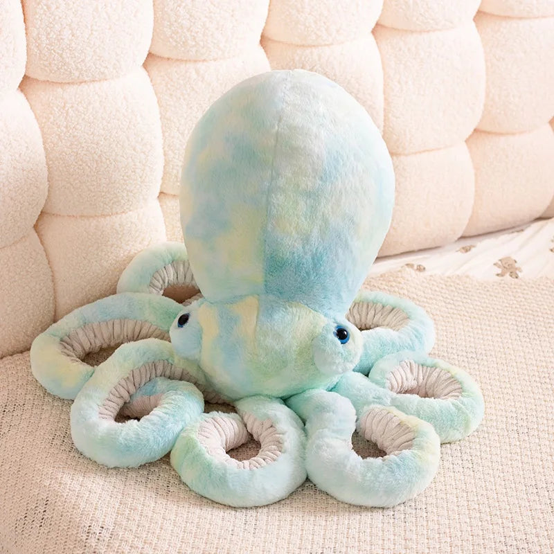 Plush octopus toy on a textured surface with a neutral background