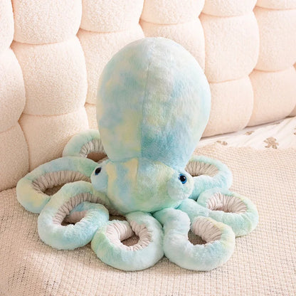Plush octopus toy on a textured surface with a neutral background