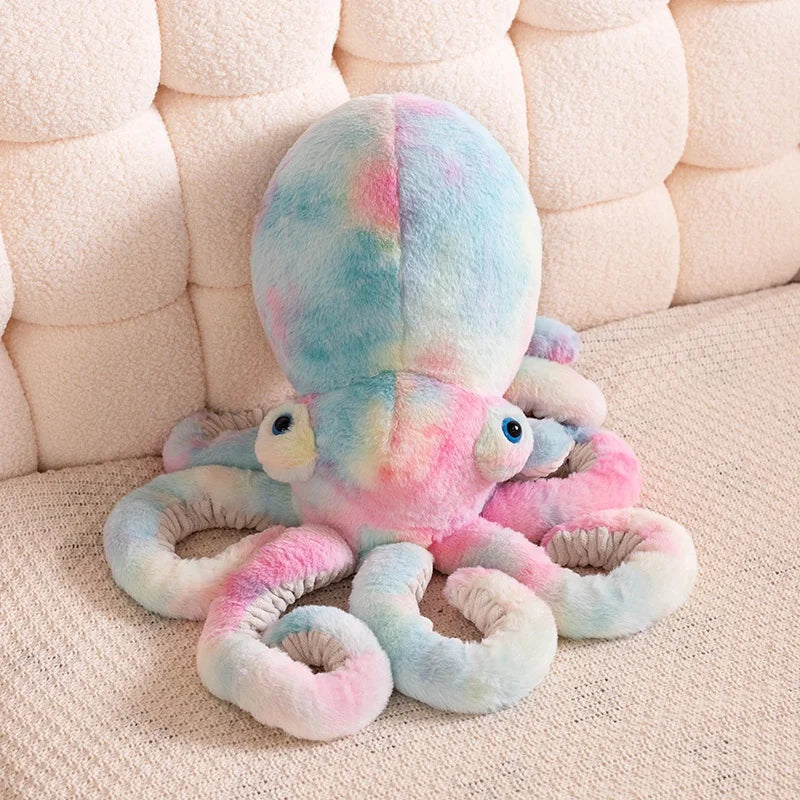 Colorful octopus plush toy on a beige couch