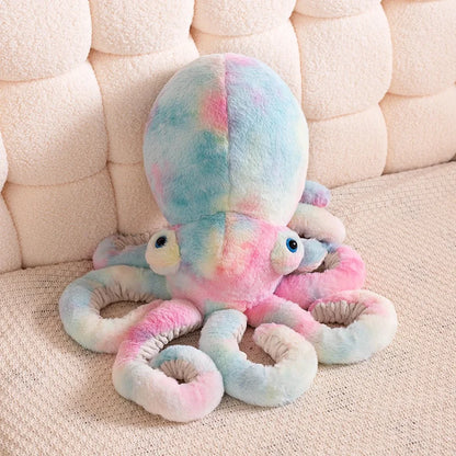 Colorful octopus plush toy on a beige couch