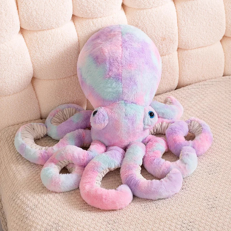 Pastel-colored octopus plush toy on a beige couch