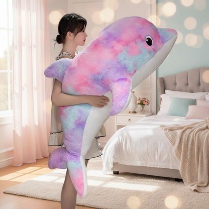 Woman holding a colorful dolphin stuffed animal in a bedroom