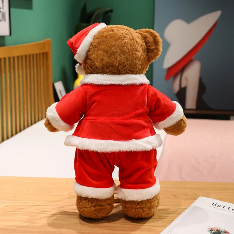Teddy bear wearing a Santa Claus outfit on a wooden surface with a colorful background.