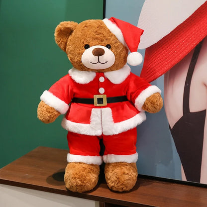 Teddy bear wearing a Santa Claus outfit on a wooden surface with a blurred background