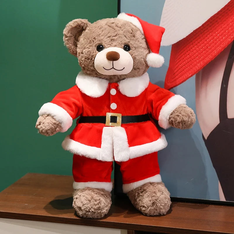 Plush teddy bear wearing a Santa Claus outfit on a wooden surface with a colorful background.