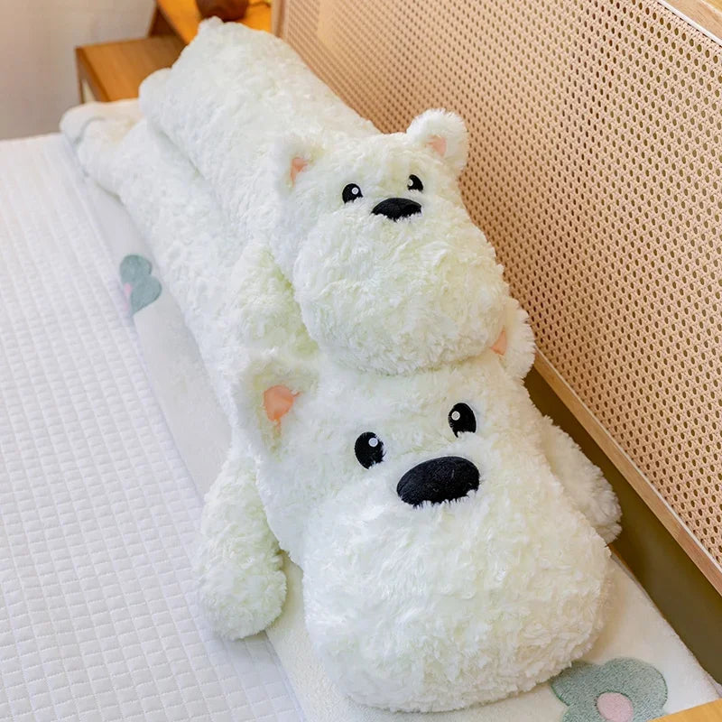 Two white dog kawaii plushie body pillow toys sitting on a bed.