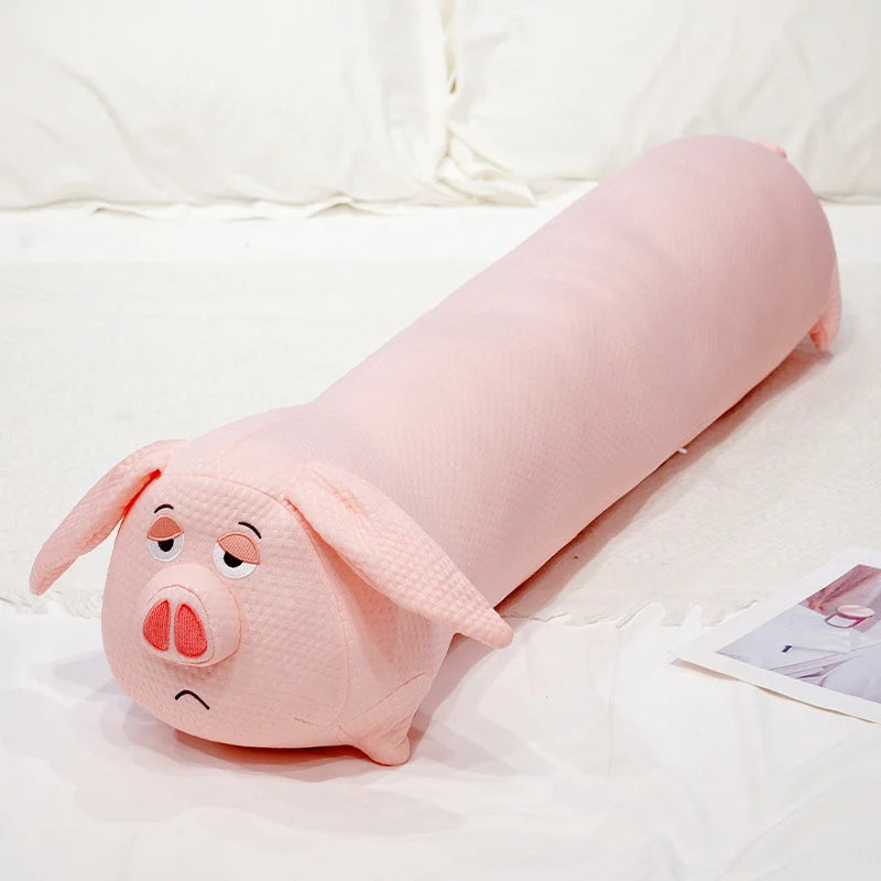 Pink pig-shaped plushie body pillow on a white bed