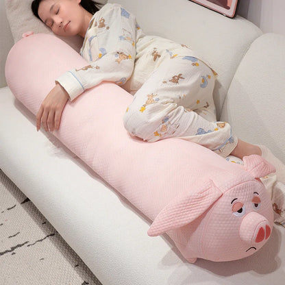Person lying on a pink pig-shaped body pillow on a couch
