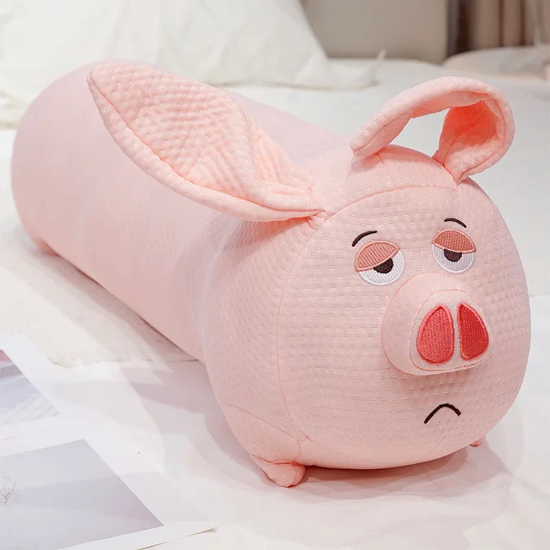 Pink pig-shaped plushie pillow on a white surface