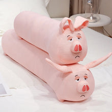 Two pink pig-shaped plushie body pillows on a bed