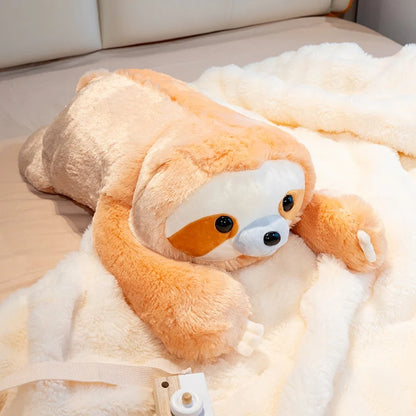 Plush toy sloth lying on a bed with a white blanket